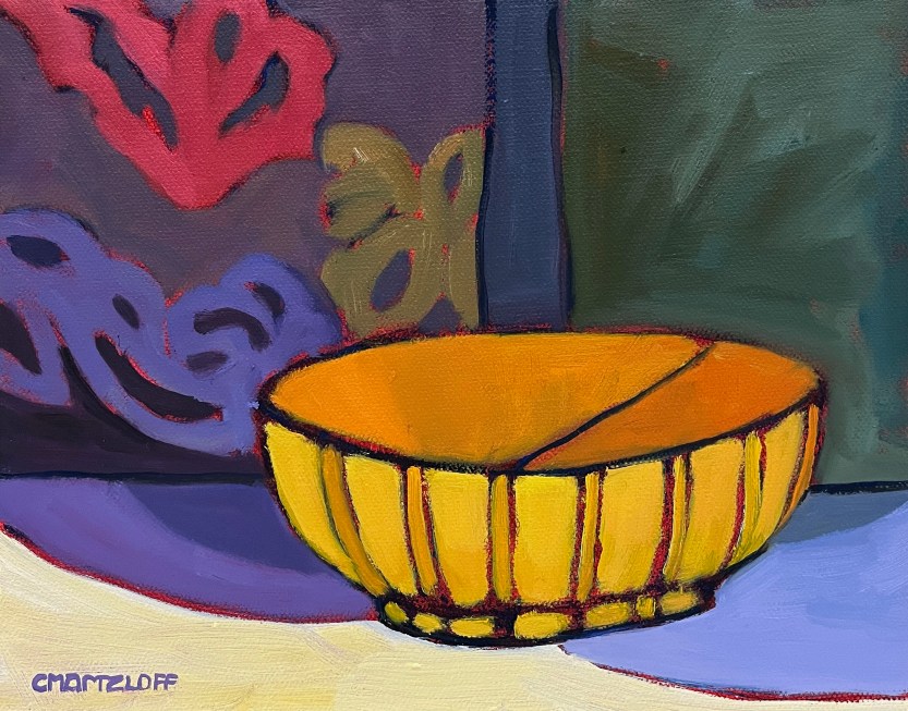 this is a minimalist still life. There are dramatic contrasts in light. Vibrant warm golds and subtle oranges are set against a dark background. A subtle abstract patterning rests in the back. This is a luminous, modern still life. A bowl is the main subject. The painting is high contrast, playful and offers a new way to experience it.